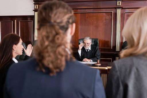 A judge lowering his glasses at an attorney, suggesting ineffective assistance of counsel.